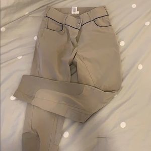 Tan riding breeches with blue pipping accent